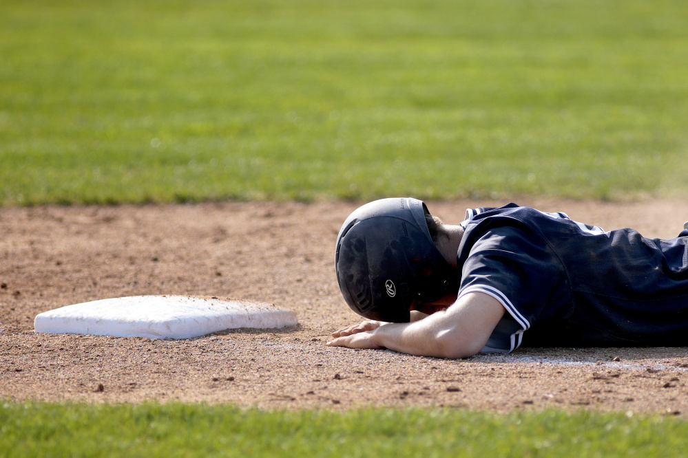 Charles Barnard of Portland takes a breather Thursday after getting picked off at first base following a single during the 8-1 victory against Cheverus. The Bulldogs reached 9-0 and will take on Bonny Eagle on Saturday.