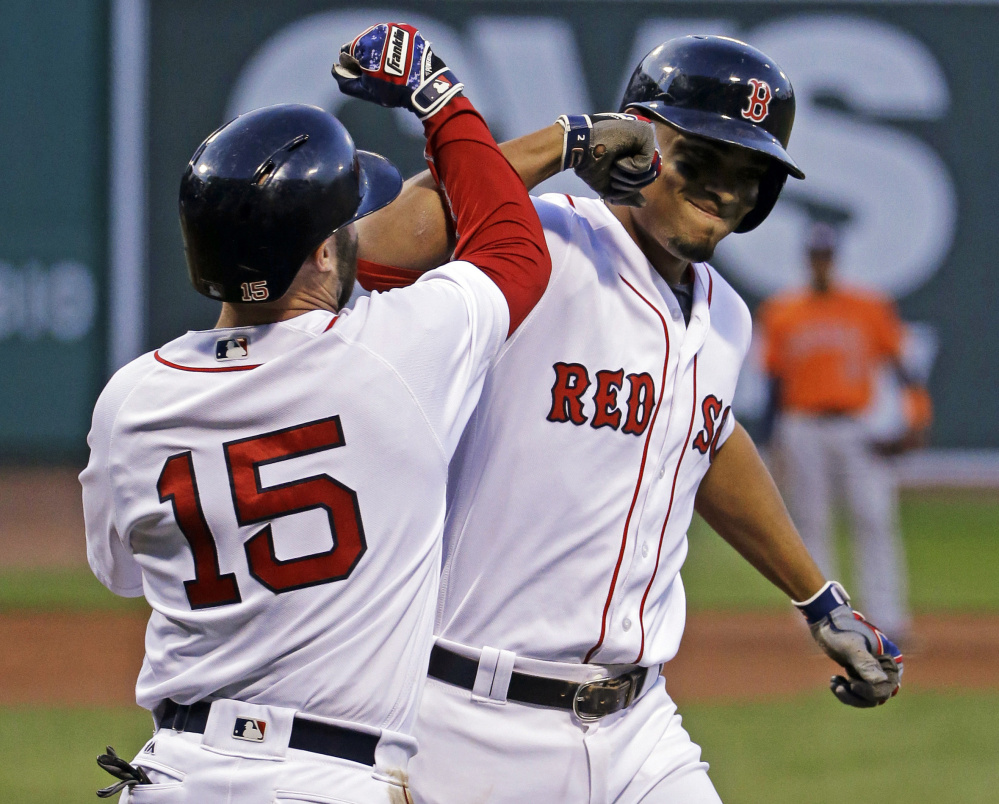 Boston's Xander Bogaerts celebrates with Dustin Pedroia after hitting a two-run home run in the first inning Thursday night in Boston.