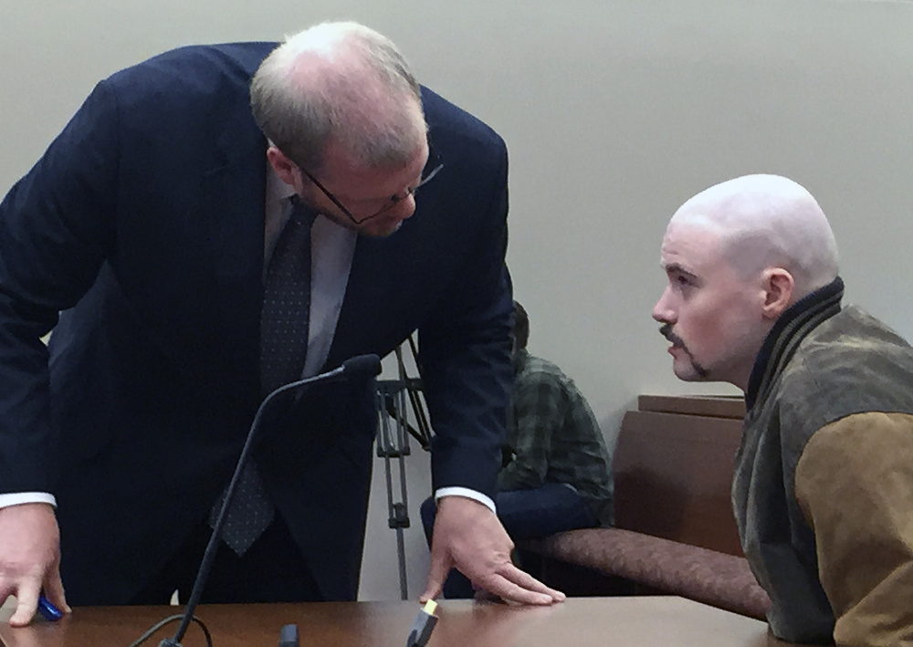 Attorney Scott Hess confers with his client, Leroy Smith III, who was ordered to be involuntarily medicated if necessary in a bid to restore his mental competence so he can stand trial on a charge of murdering his father.