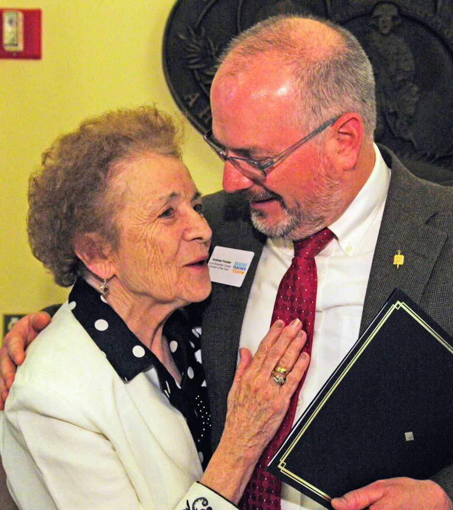 Leona Forster hugs her son, Kennebec County Teacher of the Year Andrew Forster, on Friday after a Teacher of the Year event in the State House Hall of Flags in Augusta.