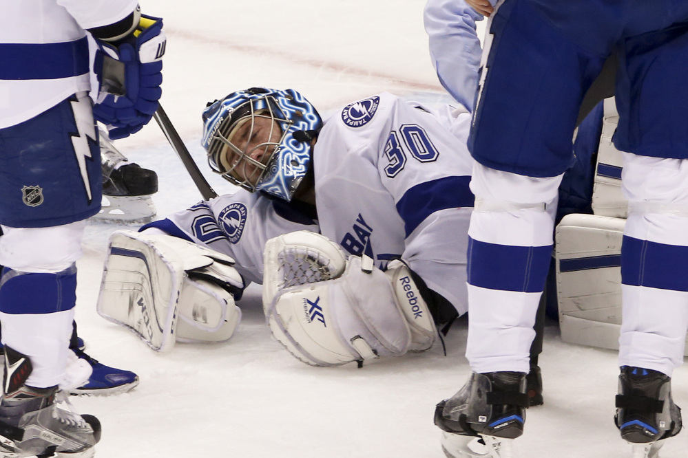 Tampa Bay goalie Ben Bishop grimaces after injuring his left leg in the first period of Game 1 against the Penguins in the Eastern Conference finals Friday in Pittsburgh.