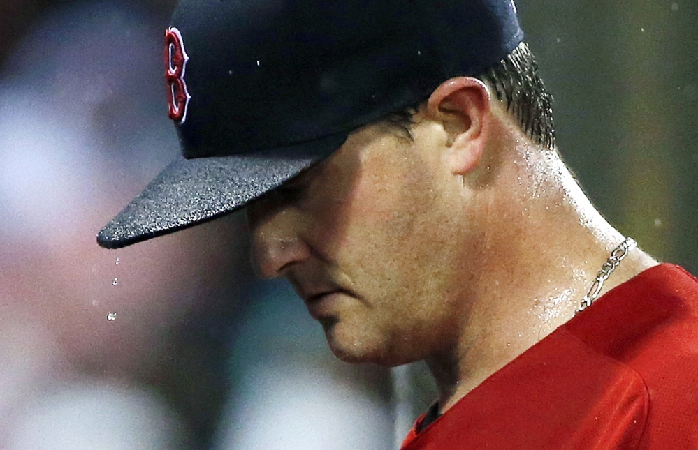 Boston's Steven Wright walks to the dugout after being taken out during the fifth inning of Friday's game at Boston.