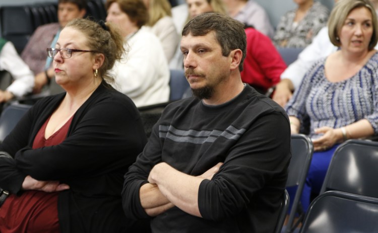 Richard Bourgeois-Lang, center, and his wife, Melissa Bourgeois-Lang, wait to hear from the SAD 6 school board Tuesday. Board rules have kept them from weighing in on Superintendent Frank Sherburne's hiring of his son in violation of the district's nepotism policy.