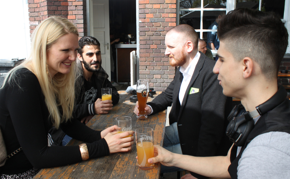 From left, Cindy Spieker, Ahmed Haj Ali, Paul Spieker and Abdul Wahab get acquainted in Berlin. The group met through a website called "Let's integrate!" So far, more Germans than refugees have signed up for the project.