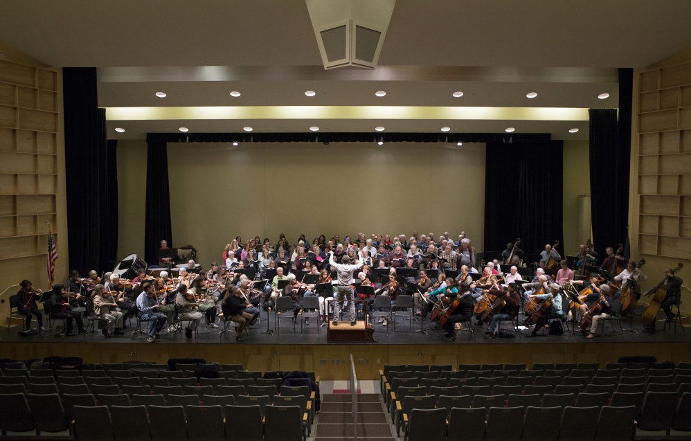 Conductor Rohan Smith, the Midcoast Symphony Orchestra and singers from the Vox Nova Chamber Choir and the Oratorio Chorale rehearse for their weekend performances.