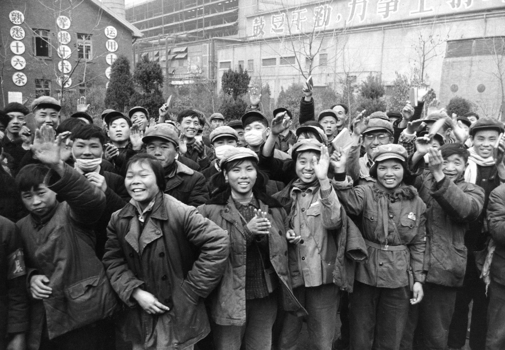 Young Chinese outside a factory wave copies of the collected writings of Communist Party Chairman Mao Zedong, often referred to as Mao's Little Red Book, in 1967.