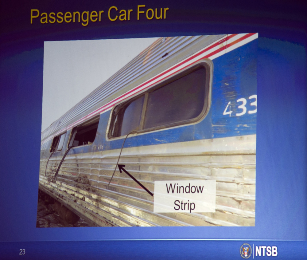 A photograph displayed on a video monitor shows a window that separated from the train car during the derailment of an Amtrak passenger train in Philadelphia last year, during a National Transportation Safety Board meeting on the derailment Tuesday in Washington.
