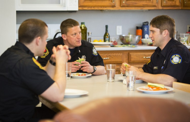 Firefighter Troy Greenip, Capt. Chris Goodall and firefighter (and cook) Ryan Thomson share a healthy lunch at Portland's Rosemont Station.