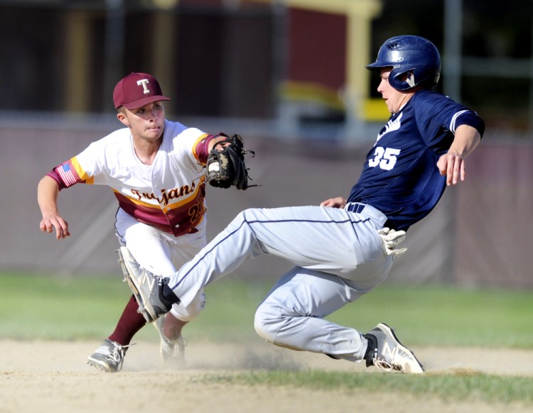 Luke Chessie of Thornton Academy puts the tag on Zach Fortin of Portland, who was attempting to steal second base, to get the second out in the sixth inning with the game tied 2-2.