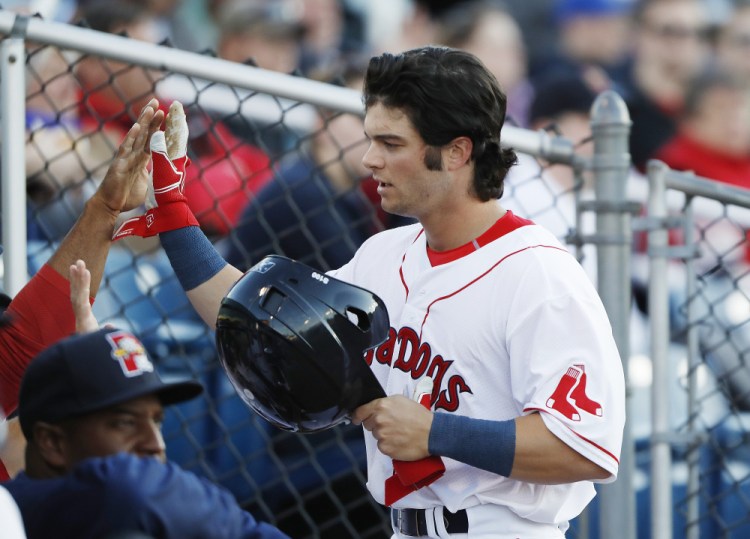 Andrew Benintendi is congratulated after scoring a run in a Sea Dogs win last month. Joel Page/Staff Photographer