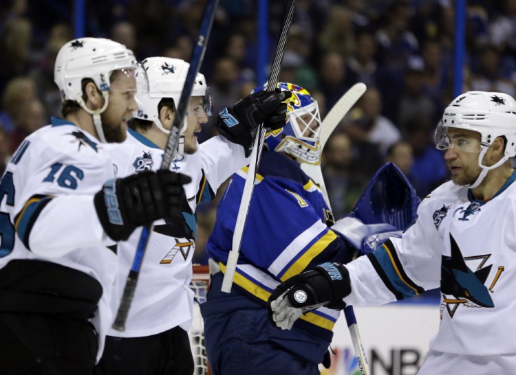 San Jose Sharks center Tommy Wingels, second from left, celebrates a goal with center Nick Spaling, left, and defenseman Justin Braun, right, during the first period of San Jose's 4-0 win over the Blues on Tuesday.
