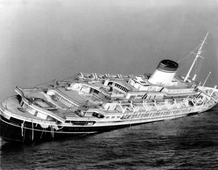 The Italian luxury liner Andrea Doria keels far over to starboard before sinking 225 feet to the bottom of the Atlantic 45 miles off Nantucket Island, Mass.