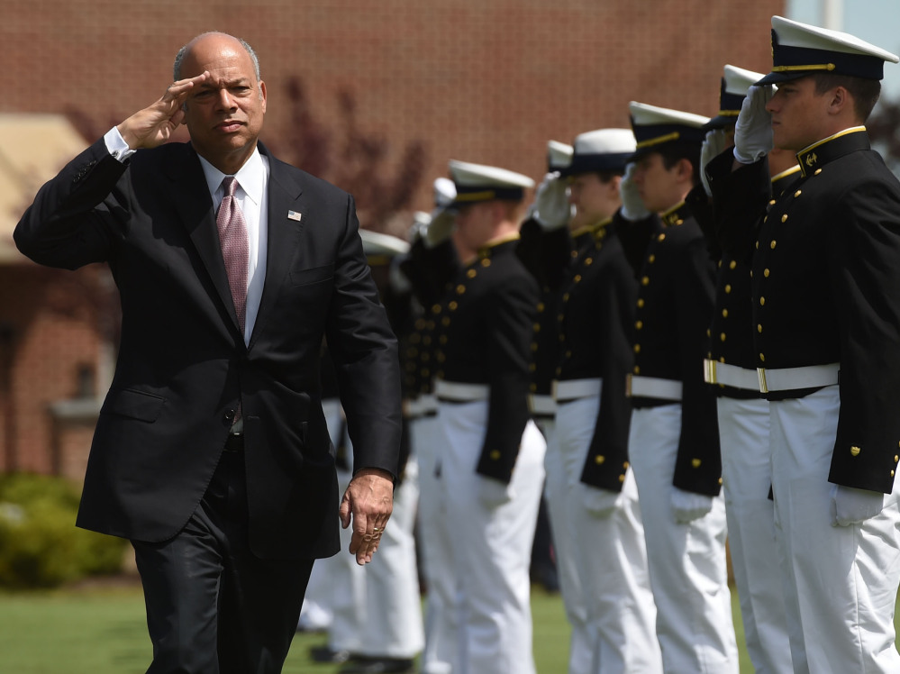 Homeland Security Secretary Jeh Johnson salutes as he passes the cadet cordon for the United States Coast Guard Academy graduation in New London, Conn., on Wednesday.