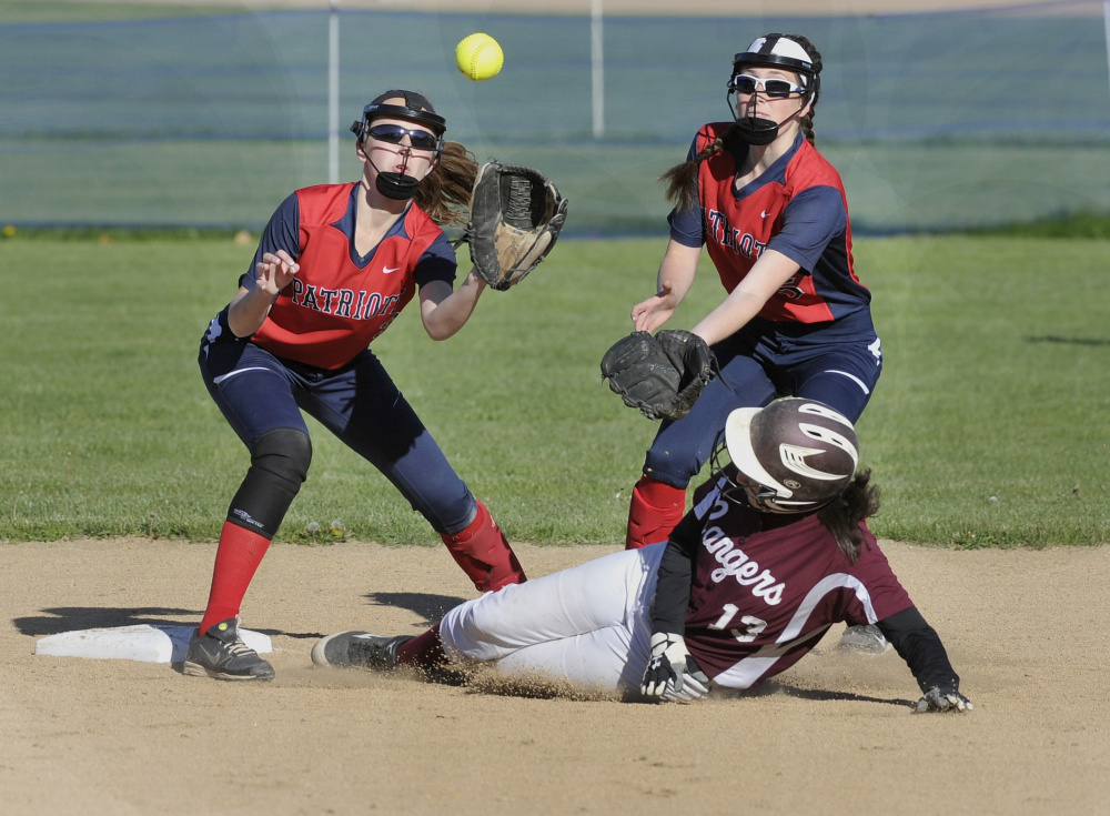 Moira Train of Greely slides safely into second base Wednesday as Gray-New Gloucester shortstop Alexa Thayer awaits a throw in front of second baseman Hannah Dixon.