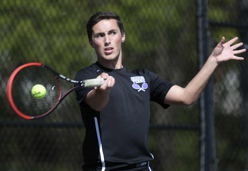 Isaac Finberg of Deering uses his forehand to return the shot to Peter Barry of Portland during their match at Deering High. Barry came away with a 6-1, 4-6, 6-3 victory.