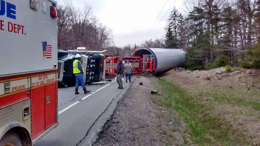 A loaded truck hauling a wind turbine towner from the Quebec border to a wind project in Bingham rolled over Monday when the driver lost control on a corner in Johnson Mountain Township. It will be removed Friday.