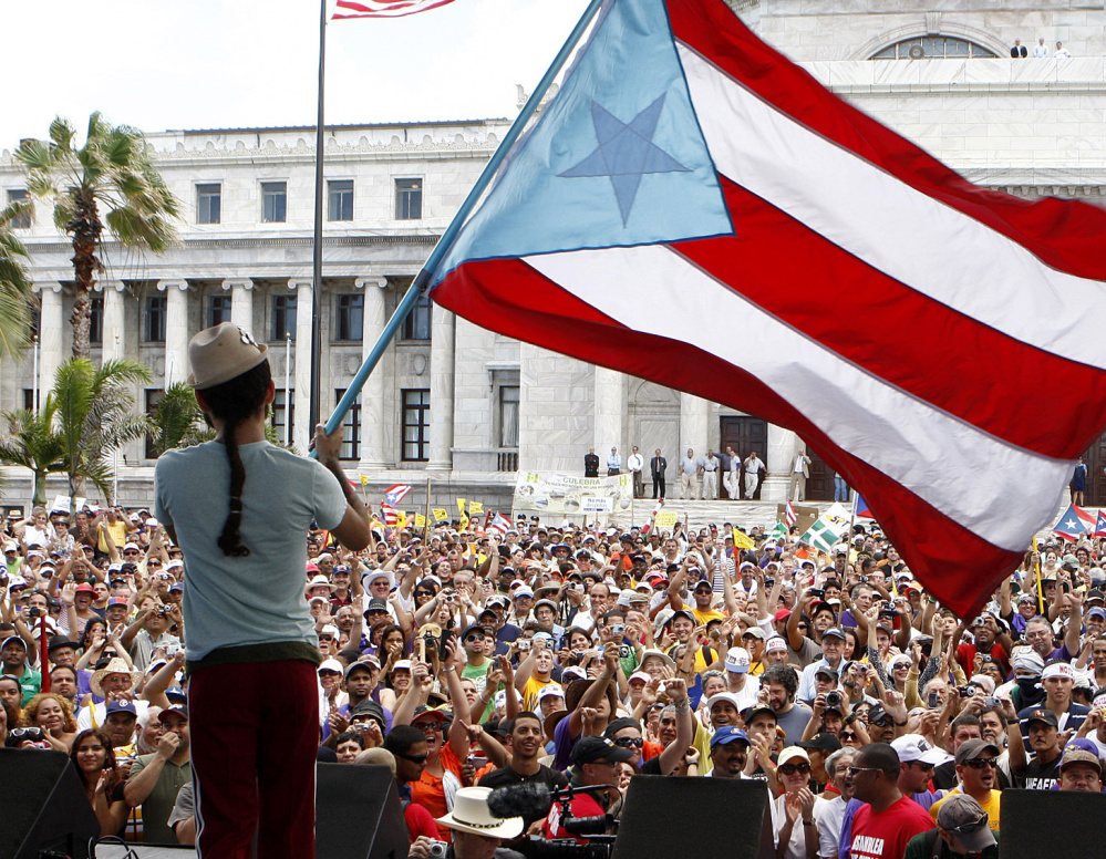 Demonstrators gather in San Juan, Puerto Rico, to protest budget cuts. The U.S. protectorate has been mired in a decade-long recession.
