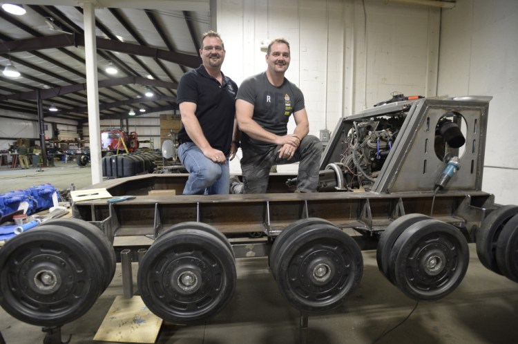 Geoffrey and Michael Howe are building the track base for a human-piloted battle robot at their Waterboro company, Howe & Howe Technologies Inc. In charge of providing the robot with speed and mobility, the Howes' tank-like base will be powered by a V8 engine. "It's going to sound like a monster truck," said Michael Howe, company president.