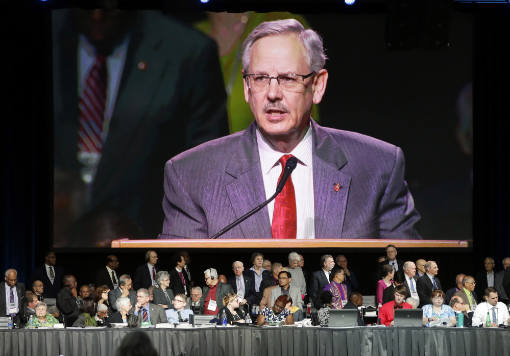 Methodist leader Bishop Bruce Ough speaks from a monitor at the church's general conference, where anguished debate over same-sex marriage and LGBT rights erupted.