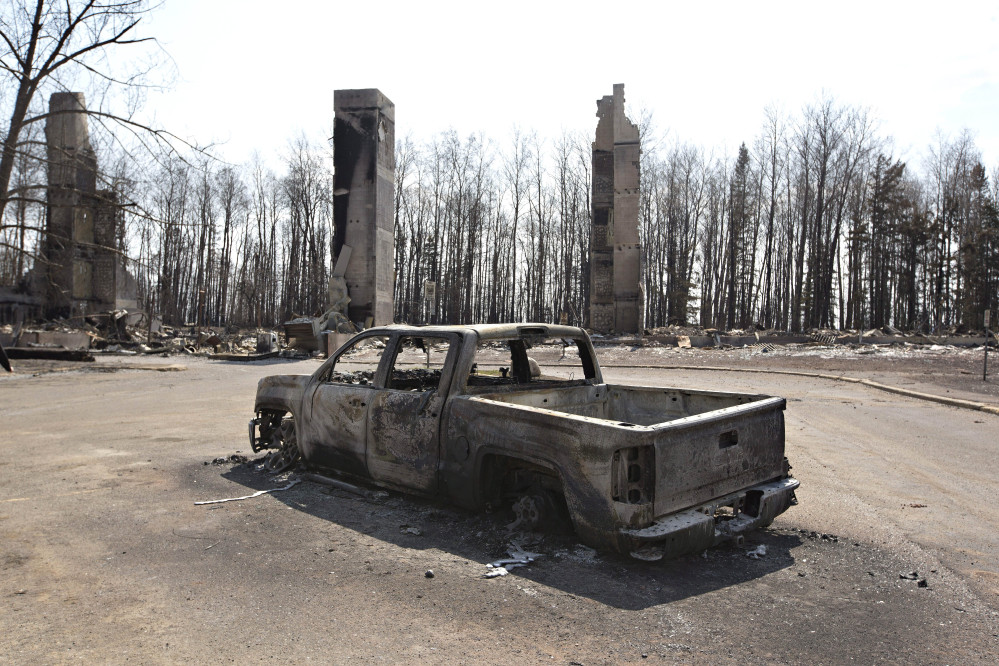 A charred truck sits near burned structures in the neighborhood of Abasand in wildfire-ravaged Fort McMurray, Alberta, on Friday.
Jason Franson /The Canadian Press via AP