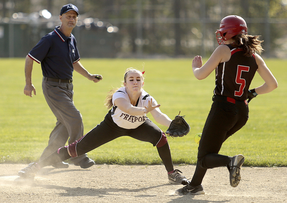 Freeport second baseman Kasey Erlebach attempts to handle a throw as Olivia Durfee of Wells arrives safely. Durfee had three of the 15 hits for Wells.