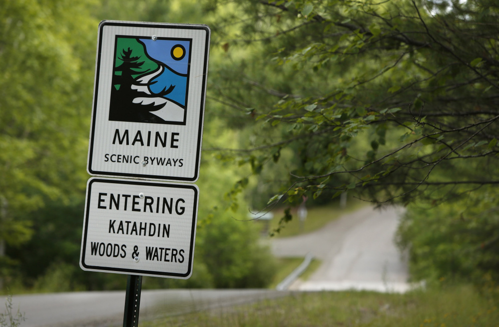 A sign near the north entrance to Baxter State Park along Grand Lake Road indicates the start of a scenic byway connected with the Katahdin Woods & Waters recreation area.
