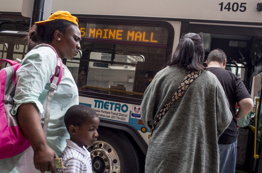 Riders board a Metro bus at the Elm Street station. Metro is expanding service to Freeport and, along with South Portland's bus service and Casco Bay Lines, launching an app to help riders track pickup times on their smartphones, above.