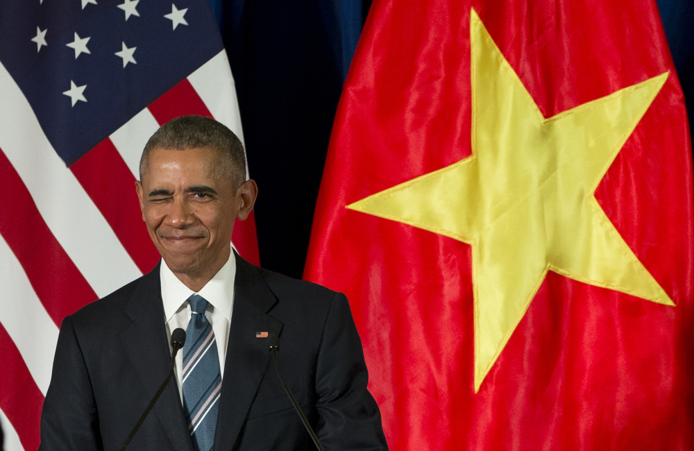 President Obama winks as he arrives for a news conference with Vietnamese President Tran Dai Quang Monday at the International Convention Center in Hanoi, Vietnam.