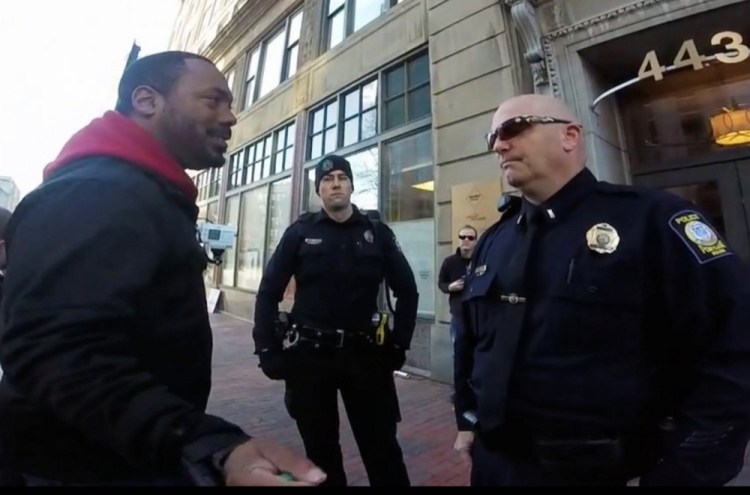 Pastor Andrew March talks with Portland police outside Planned Parenthood offices last fall. He later sued, arguing he was targeted because of his anti-abortion message.