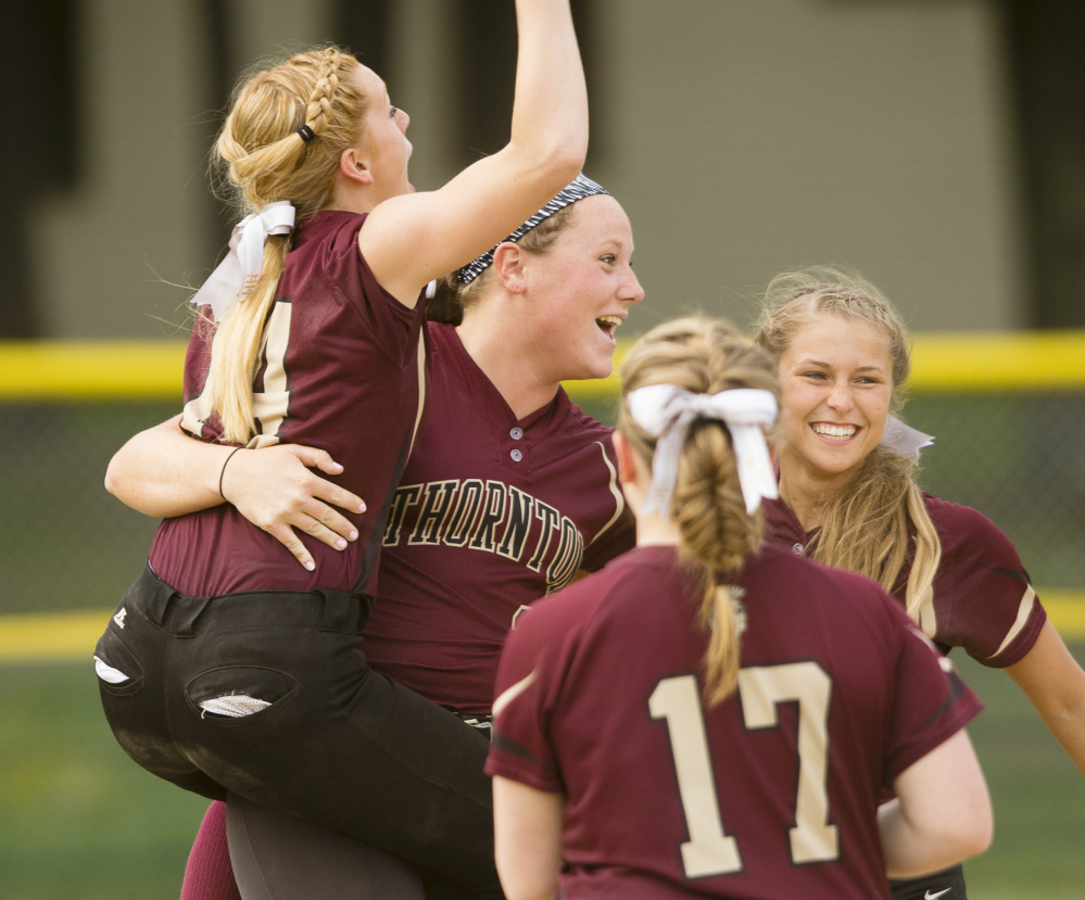 Maizie Lee, center, celebrates with Kaylee Burns, left, Libby Pomerleau, right, and Lindsay Luopa after Thornton Academy's 2-1 softball win Monday over Windham.
