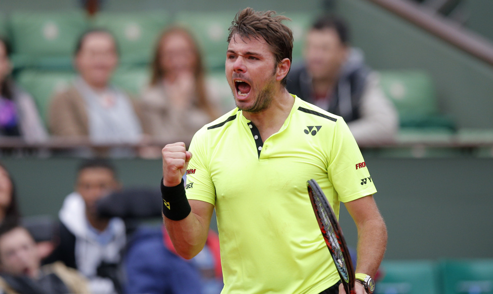 Stan Wawrinka celebrates a winning point Monday against Lukas Rosol in the opening round of the French Open. Wawrinka, the defending champ, won 4-6, 6-1, 3-6, 6-3, 6-4.