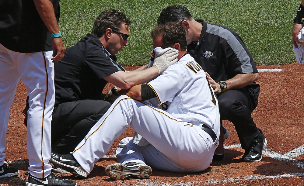 Pittsburgh pitcher Ryan Vogelsong is attended to by team trainers after being hit in the head by a pitch from Colorado's Jordan Lyles in the second inning at Pittsburgh on Monday. Voglesong was later admitted to a hospital with injuries to his left eye.
