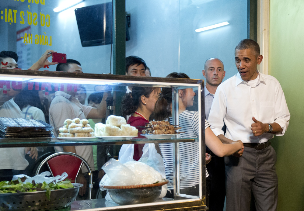 President Barack Obama greets women at the door as he walks from the Bún chả Hương Liên restaurant after having dinner with American Chef Anthony Bourdain in Hanoi, Vietnam, Monday, May 23, 2016. (AP Photo/Carolyn Kaster)