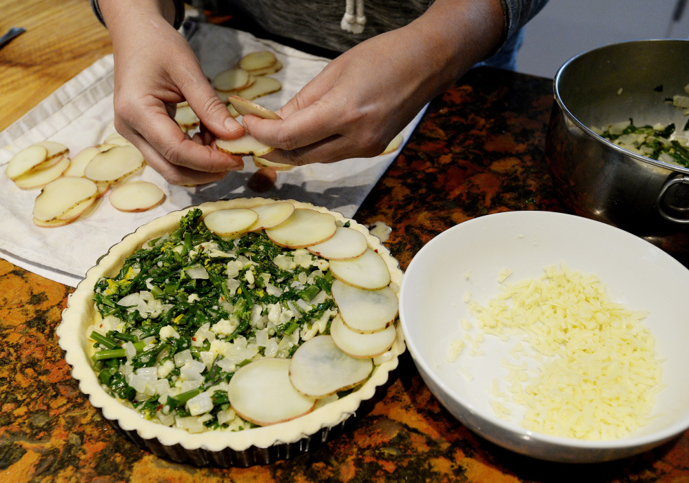 Thinly sliced potatoes are added to the top of the tart.