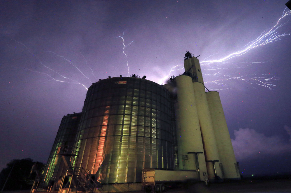 Lightning from a severe storm fills the sky behind a grain elevator in Belvue, Kan., on Wednesday. The storm produced tornadoes near Chapman.