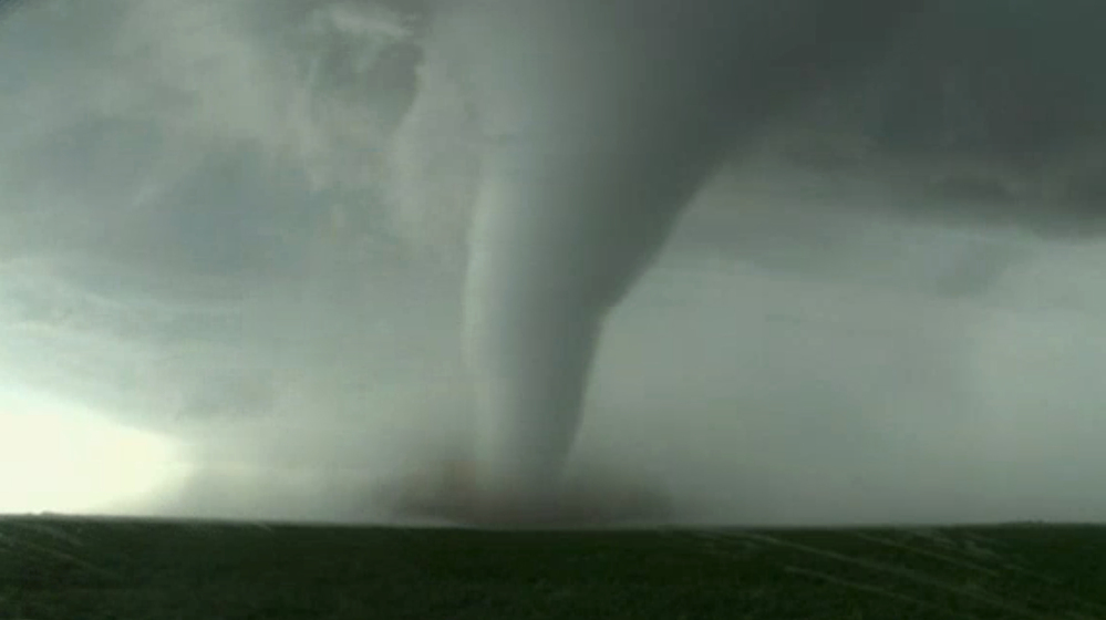 Image made from a video by KWTV-KOTV shows a funnel cloud moving across a field near Dodge City in Ford County, Kan., on Tuesday. Tornadoes destroyed several homes in western Kansas as a series of severe storms swept across the Plains.