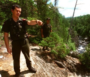 Warden Roger Guay points out a dangerous area along the hiking trail at Gulf Hagas to fellow Warden Pat Dorian in 1995. Guay, who retired after 25 years with the Maine Warden Service, has been involved in more searches for missing people than he can count. He said hikers have to be prepared, to stay alive and to help searchers find them.