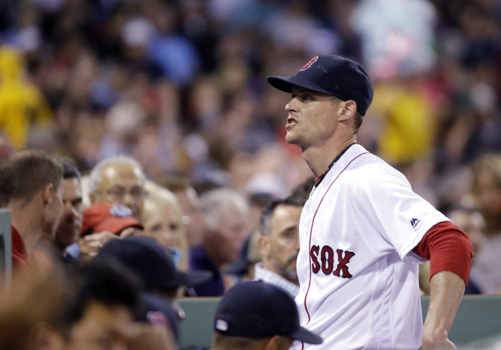 Red Sox starter Clay Buchholz says something to fans as he walks into the dugout after the fifth inning of Thursday's game at Fenway Park against the Colorado Rockies.