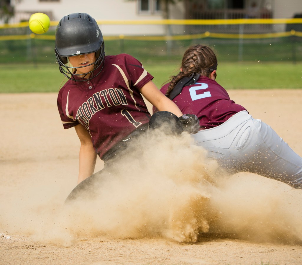 Thornton Academy's Libby Pomerleau slides safely into third as Windham third baseman Alex Morang can’t handle the  throw in the third inning Monday. Pomerleau advanced to score what proved to be the winning run.
Carl D. Walsh/Staff Photographer