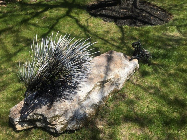 A porcupine sculpture has been donated to replace the one stolen from the road into the Portland International Jetport. It portrays a mother porcupine followed by her baby, visible at right.