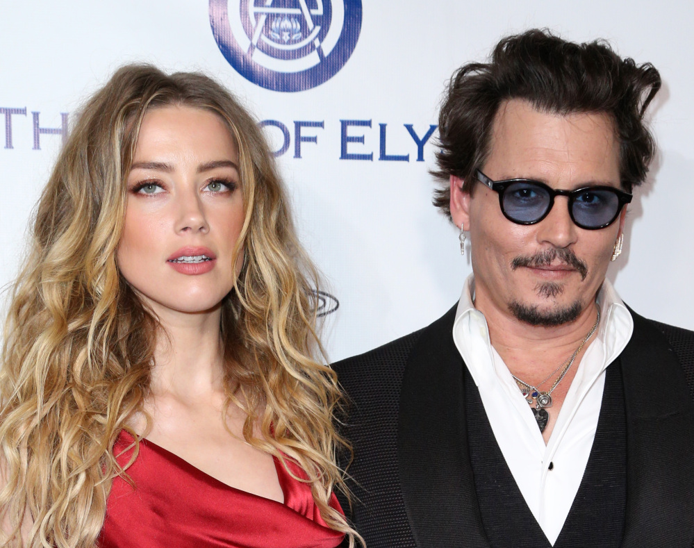 Amber Heard and Johnny Depp arrive at an event in Culver City, Calif., in January. A judge ruled Friday that Depp shouldn't contact Heard until a hearing on June 17.
The Associated Press