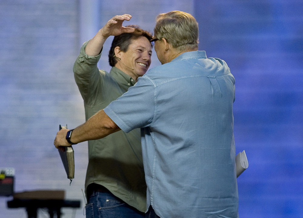 Danny Duchene is greeted by Rick Warren in April during a Sunday service. After 32 years in prison, Duchene was freed, partly in response to a letter from Warren asking the parole board to allow him to hire Duchene as a pastor in his Saddleback Church's prison ministry.