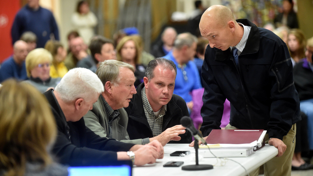 Waterville Detective Sgt. Bill Bonney, far right, talks to schools Superintendent Eric Haley, left center, Nov. 11, during the hearing to terminate Don Reiter, the principal at Waterville Senior High School. Bonney helped lead the police part of the investigation.
