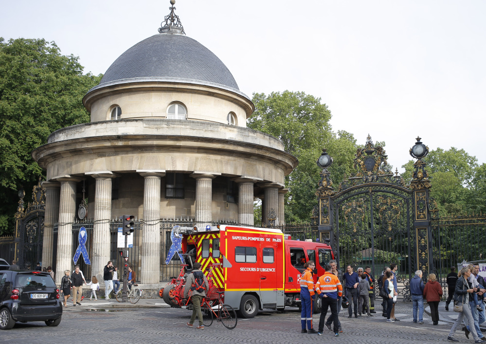 A fire truck is parked at the entrance to Parc Monceau in Paris on Saturday, after lightning struck eight children and three adults at a children's birthday party.