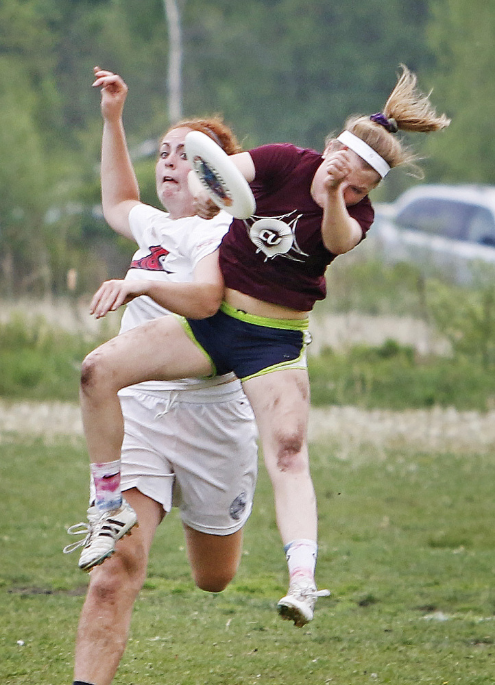 Lily Black of Cumberland makes a catch with pressure from Bridget Bailey of Fryeburg Academy during high school Ultimate state championships at Wainwright Sports Complex. 
Jill Brady/Staff Photographer
