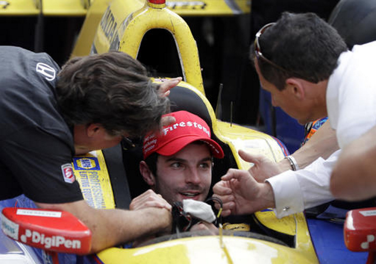 Alexander Rossi, center, celebrates with car owner Michael Andretti, left, after winning the 100th running of the Indy 500 on Sunday.
