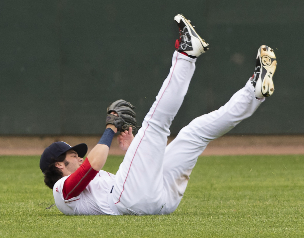 Sea Dogs outfielder Andrew Benintendi rolls over after making a shoestring catch in the second inning of Portland's 6-3 loss to Hartford on Sunday at Hadlock Field.