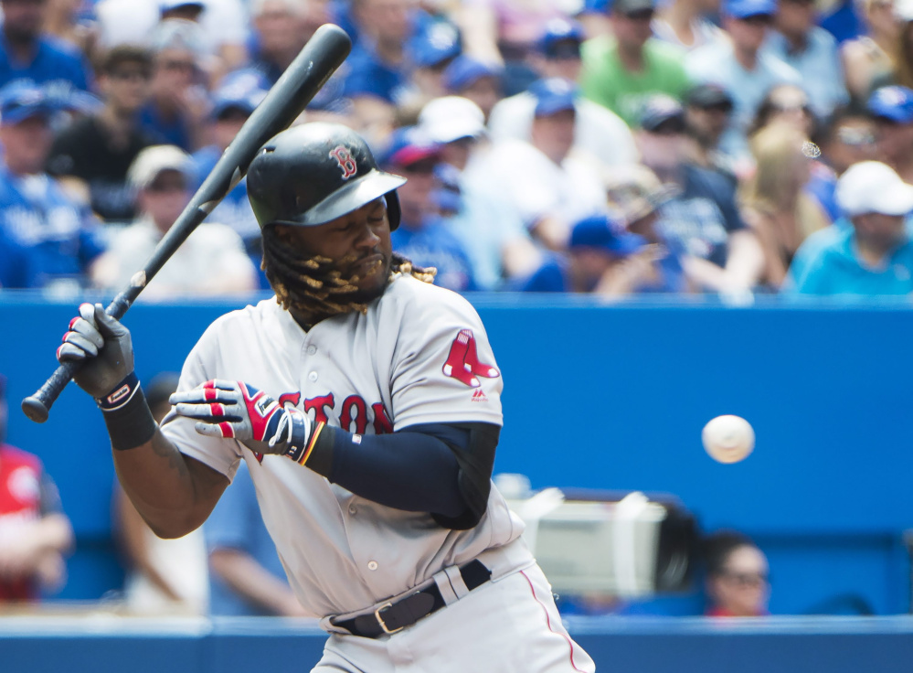 Red Sox designated hitter Hanley Ramirez is hit by a pitch with the bases loaded in the sixth inning against the Toronto Blue Jays on Sunday in Toronto. Boston scored twice in the sixth to take a one-run lead and twice in the 11th to win 5-3.