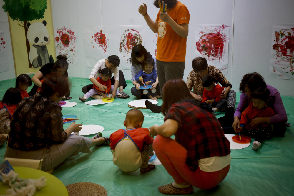 Children and their parents and caretakers attend an art class at the I Love Gym center in Beijing, China, earlier this month. The rise in use of in vitro fertilization points to the deferred dreams of many Chinese parents who had long wanted a second child.