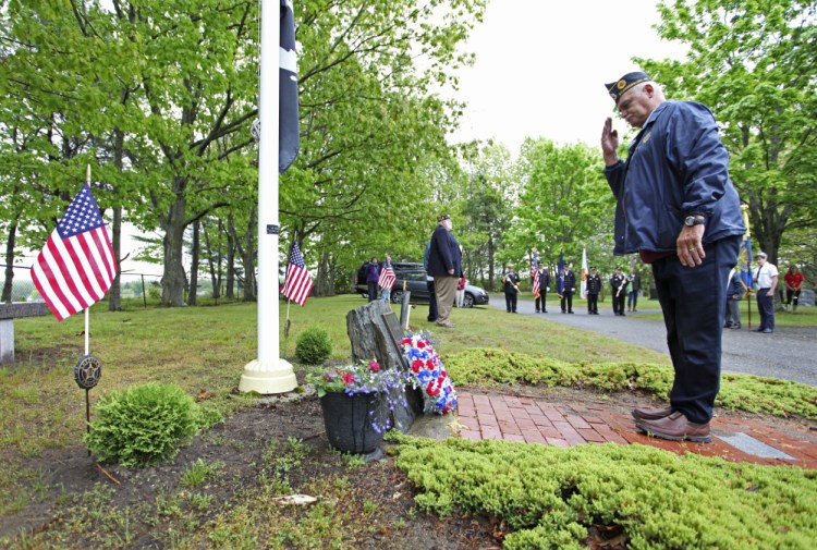 Phil Ceaser, commander of American Legion Post 76 in Scarborough, salutes after laying a memorial wreath at Black Point Cemetery during Memorial Day services in Scarborough on Monday.